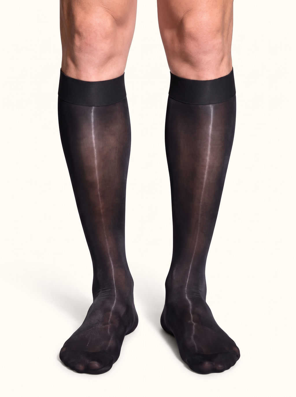 Front view of a man standing in NYLO 10D sheer black dress socks below the knee