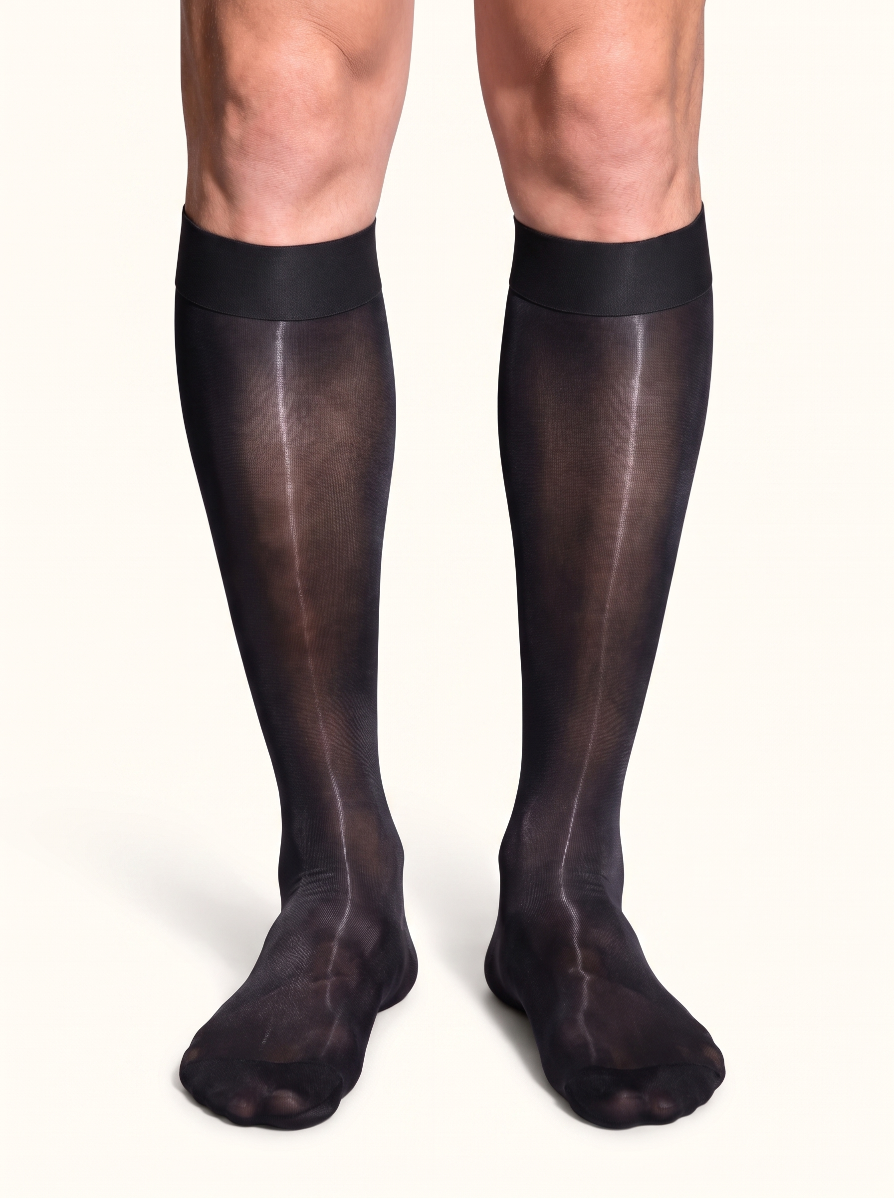 Front view of a man standing in NYLO 10D sheer black dress socks below the knee
