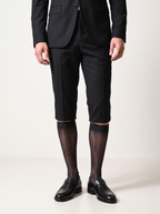 Man in a black blazer and tailored shorts wearing NYLO 10D sheer black dress socks with black loafers