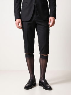 Man in a black blazer and tailored shorts wearing NYLO 10D sheer black dress socks with black loafers